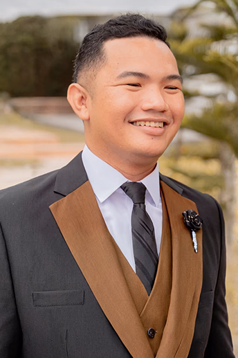Half-body professional portrait of Khel Ochagabia, owner at Digitarize, smiling in formal attire.
